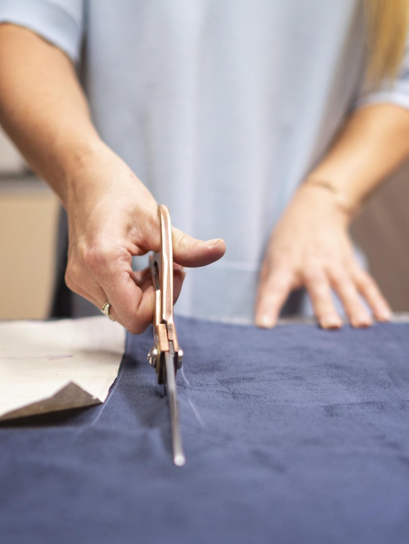 close-up-hand-cutting-material